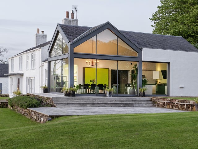 Exterior: The 53-acre grounds include outbuildings, including one used as a gym, parking spaces, three storage barns, and a decked terrace and gardens with commanding sea views.