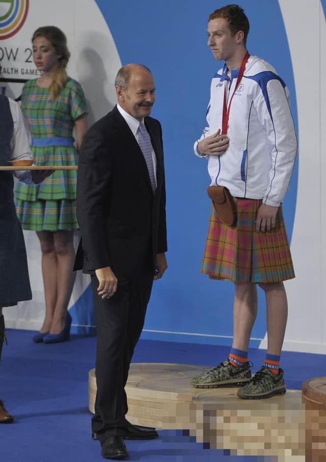 David Wilkie presents Dan Wallace with his medal at the 2014 Commonwealth Games in Glasgow. Wilkie toyed with making a comeback at the Games at the age of 60. Picture Ian Rutherford


©Ian Rutherford 
ianrutherfordphotography@gmail.com
www.ianrutherfordphotography.com
07710337520