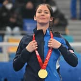 Gold medallist Eve Muirhead poses on the podium during the women's curling victory ceremony at the Beijing 2022 Winter Olympic Games. (Photo by LILLIAN SUWANRUMPHA/AFP via Getty Images)