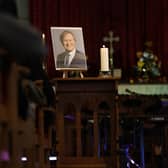 A picture of Sir David Amess stands at the front of the church during a service for the MP at St Michael and All Angels church (Photo by Hollie Adams/Getty Images)