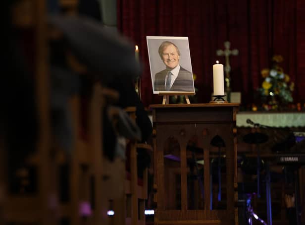 A picture of Sir David Amess stands at the front of the church during a service for the MP at St Michael and All Angels church (Photo by Hollie Adams/Getty Images)