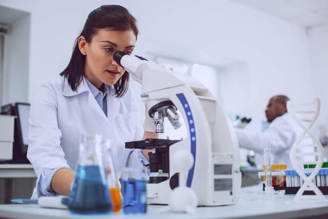 Scientist working with her microscope