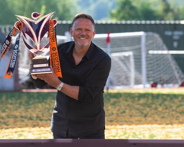 Scott Booth celebrates with the SWPL trophy after leading Glasgow City to the title earlier this year