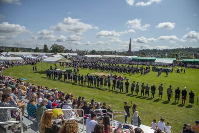 Crowds watch the massed bands at the start of the 2019 Aboyne Highland Games - credit Harry Scott (Deeside Camera Club)
