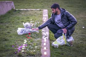 Adnan Hanif, uncle of Fawziyah Javed, lays flowers during a vigil held in honour of Fawziyah.