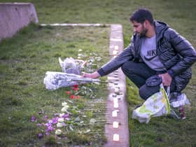 Adnan Hanif, uncle of Fawziyah Javed, lays flowers during a vigil held in honour of Fawziyah.
