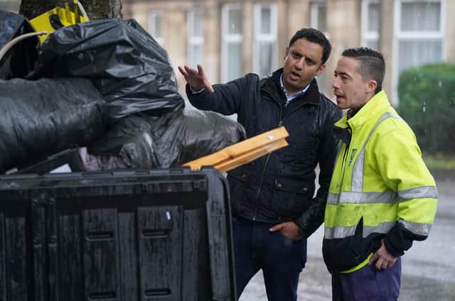 Scottish Labour leader Anas Sarwar is shown an overflowing bin by Barry McAreavey as he meets GMB cleansing workers in Glasgow to learn about their dispute with the Scottish Government ahead of Cop26. Picture date: Friday October 29, 2021.
