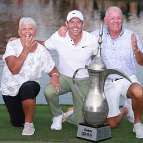 Rory McIlroy celebrates with his parents, Rosie and Gerry, after landing a record fourth win in the Hero Dubai Desert Classic at Emirates Golf Club. Picture: Warren Little/Getty Images.
