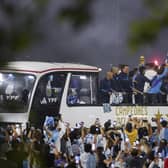 Players of the Argentine soccer team that won the World Cup arrive to the training grounds where they will spend the night after landing at Ezeiza airport on the outskirts of Buenos Aires, Argentina, Tuesday, Dec. 20, 2022. (AP Photo/Matilde Campodonico)