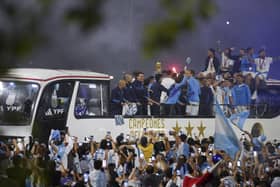 Players of the Argentine soccer team that won the World Cup arrive to the training grounds where they will spend the night after landing at Ezeiza airport on the outskirts of Buenos Aires, Argentina, Tuesday, Dec. 20, 2022. (AP Photo/Matilde Campodonico)