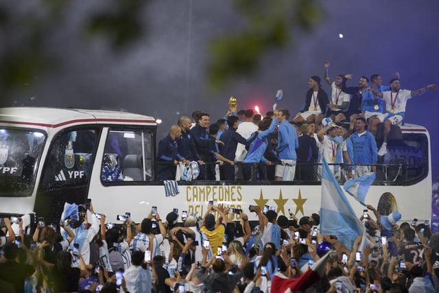 Players of the Argentine soccer team that won the World Cup arrive to the training grounds where they will spend the night after landing at Ezeiza airport on the outskirts of Buenos Aires, Argentina, Tuesday, Dec. 20, 2022. (AP Photo/Matilde Campodonico)