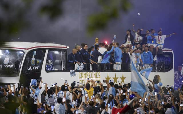 Players of the Argentine soccer team that won the World Cup arrive to the training grounds where they will spend the night after landing at Ezeiza airport on the outskirts of Buenos Aires, Argentina, Tuesday, Dec. 20, 2022. (AP Photo/Matilde Campodonico)