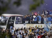 Players of the Argentine soccer team that won the World Cup arrive to the training grounds where they will spend the night after landing at Ezeiza airport on the outskirts of Buenos Aires, Argentina, Tuesday, Dec. 20, 2022. (AP Photo/Matilde Campodonico)