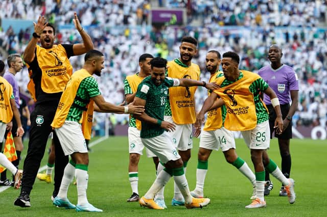 Saudi Arabia's Salem Al-Dawsari celebrates with team-mates after scoring the winning goal against Argentina.