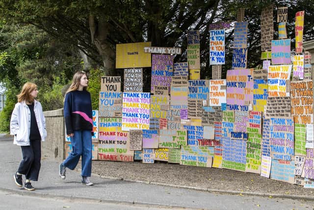 A new artwork greets visitors at Jupiter Artland, Edinburgh, created as a tribute to the NHS titled "A Thousand Thank Yous" originally devised by the late Allan Kaprow which consists of colourful painted messages on cardboard and has been directed remotely by London-based artist Peter Liversidge.