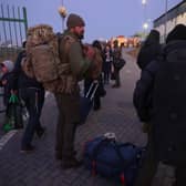 Two men from London prepare to cross into Ukraine at the Medyka border crossing in Poland. In a report issued by the Ukrainian army stating the creation of a foreign legion unit for international volunteers, Ukraine's President Zelensky appealed to foreign nationals to join his army in the fight against Russia.