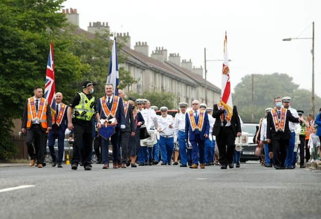 A silent Orange Order band marches through the streets of Easterhouse in Glasgow. (Photo: Robert Perry/PA Wire).