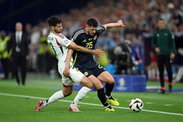Scott McKenna of Scotland is challenged by Dominik Szoboszlai of Hungary during the UEFA EURO 2024 group stage match between Scotland and Hungary.
