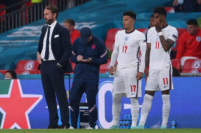 England manager Gareth Southgate brought both Jadon Sancho (L) and Marcus Rashford on in the last minute of extra-time. Both failed to score their penalties.  (Photo by LAURENCE GRIFFITHS/POOL/AFP via Getty Images)