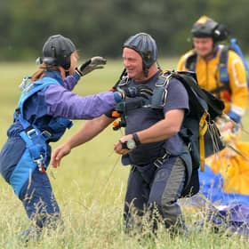 The public raises money for charities through events like sponsored parachute jumps, while charities have considerable influence on society (Picture: Barry Batchelor/PA)