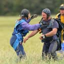 The public raises money for charities through events like sponsored parachute jumps, while charities have considerable influence on society (Picture: Barry Batchelor/PA)