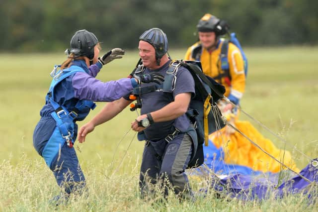 The public raises money for charities through events like sponsored parachute jumps, while charities have considerable influence on society (Picture: Barry Batchelor/PA)