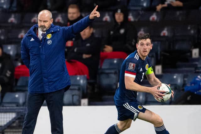 Andy Robertson in action for Scotland as manager Steve Clarke watches on during a FIFA World Cup Qualifier between Scotland and Denmark at Hampden Park.
