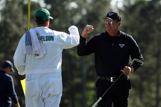 Phil Mickelson fist bumps his caddie, brother Tim, on the 18th green during the final round of the 2023 Masters. Picture: Patrick Smith/Getty Images.