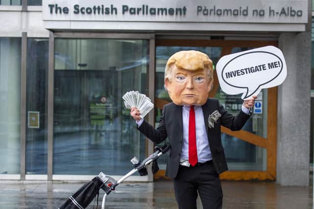 A demonstration calling for an investigation into Mr Trump's finances, organised by the campaign organisation, Avaaz, was staged outside the Scottish Parliament ahead of the vote. Picture: Lisa Ferguson