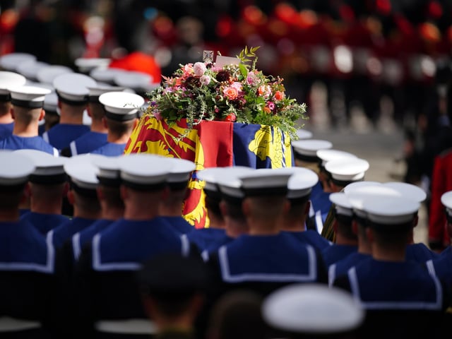 The State Gun Carriage carries the coffin of Queen Elizabeth II, draped in the Royal Standard with the Imperial State Crown and the Sovereign's orb and sceptre with a message from King Charles III, in the Ceremonial Procession following her State Funeral at Westminster Abbey, London. Picture date: Monday September 19, 2022.