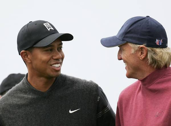 Tiger Woods and Greg Norman share a joke during the 133rd Open Championship at Royal Troon. Picture: Ross Kinnaird/Getty Images.