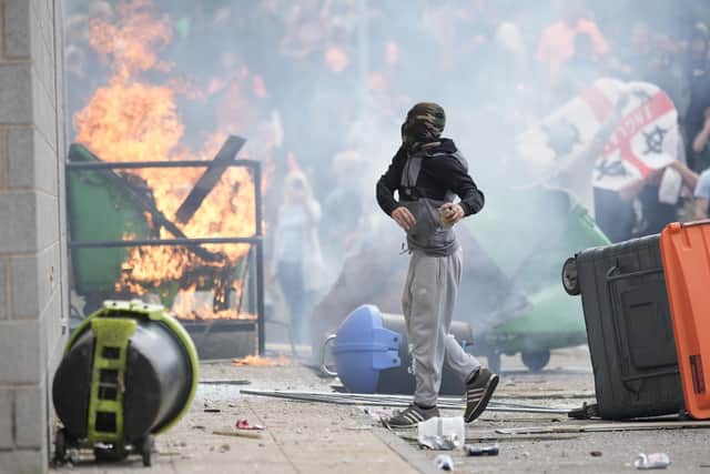 Anti-migration protesters riot outside of the Holiday Inn Express in Rotherham last week.