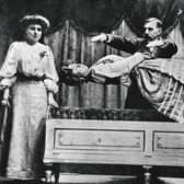 Conjuror Signor Martino performs a levitation on stage c.1900