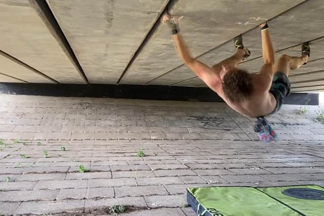 Phillips in the middle of one of the crux moves of the climb, switching from one crack to another