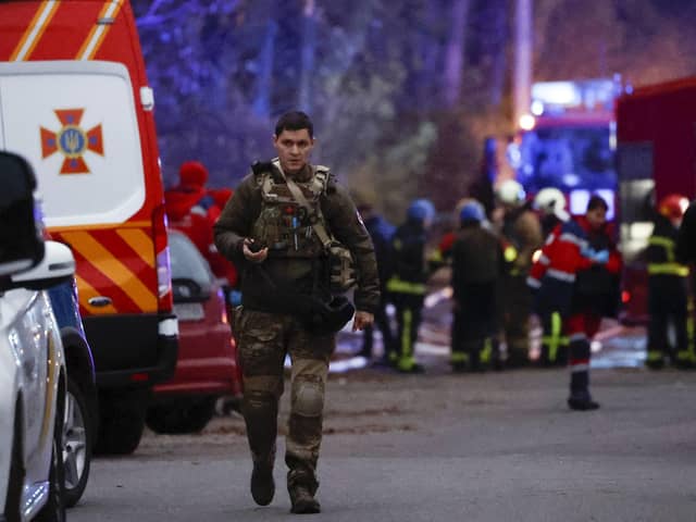 Rescue workers at the scene of a missile strike in the Pechers district in Kyiv, Ukraine.