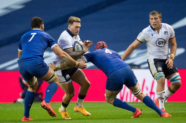 Scotland's Stuart Hogg tries to find a way past Charles Ollivon and Bernard Le Roux of France. Picture: Ross Parker / SNS