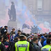 Police officers monitor as Rangers fans celebrate in George Square in Glasgow on May 15, 2021. (Photo by ANDY BUCHANAN/AFP via Getty Images)