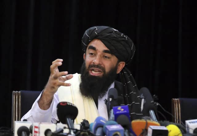 Taliban spokesman Zabihullah Mujahid speaks at his first news conference, in Kabul, Afghanistan, Tuesday, Aug. 17, 2021. Mujahid vowed Tuesday that the Taliban would respect women's rights, forgive those who resisted them and ensure a secure Afghanistan as part of a publicity blitz aimed at convincing world powers and a fearful population that they have changed. (AP Photo/Rahmat Gul)