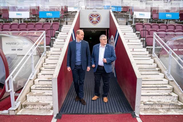 Britain's Prince William, Duke of Cambridge walks with Billy Watson, chief executive of the charity SAMH (Scottish Association for Mental Health), as they enter the pitch at Tynecastle Park. (Photo by JANE BARLOW/POOL/AFP via Getty Images)