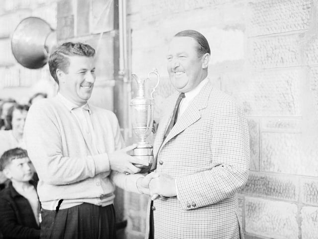 Peter Thomson presents winner Bobby Locke with the Claret Jug at the 1957 Open Championship in St Andrews.