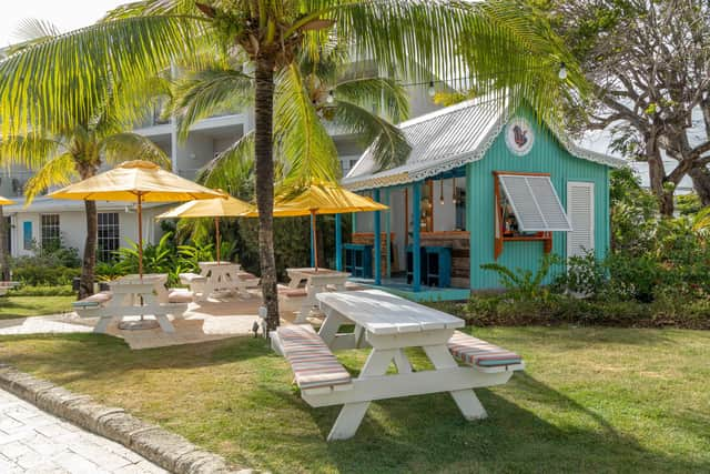 The resort's lush green gardens and De Rum Shop Cafe. Image: Steven Graffham