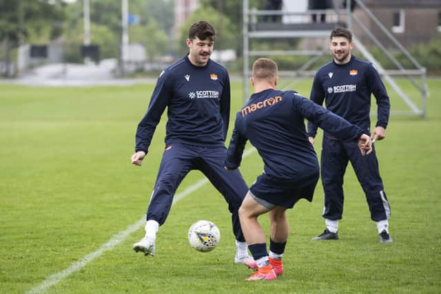Blair Kinghorn, left, shows off his football skills. He played for Hearts as a youth. (Photo by Paul Devlin / SNS Group)