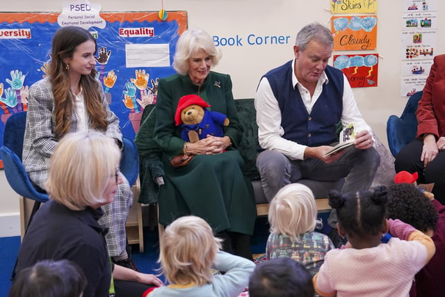 The Queen Consort with actors Madeleine Harris, Hugh Bonneville during a special teddy bears picnic at a Barnardo's Nursery in Bow, London, where she personally delivered Paddington bears and other cuddly toys, which were left as tributes to Queen Elizabeth II at Royal Residences, to children supported by the charity.