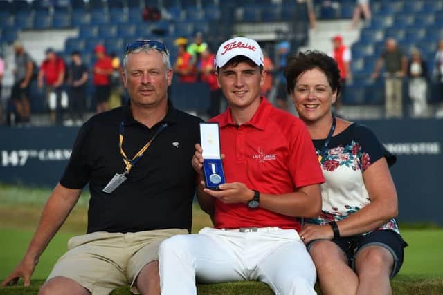 Sam Locke, flanked by his parents, shows off the Silver Medal after finishing as leading amateur in 2018 Open at Carnoustie. Picture: Andy Buchanan/AFP via Getty Images.