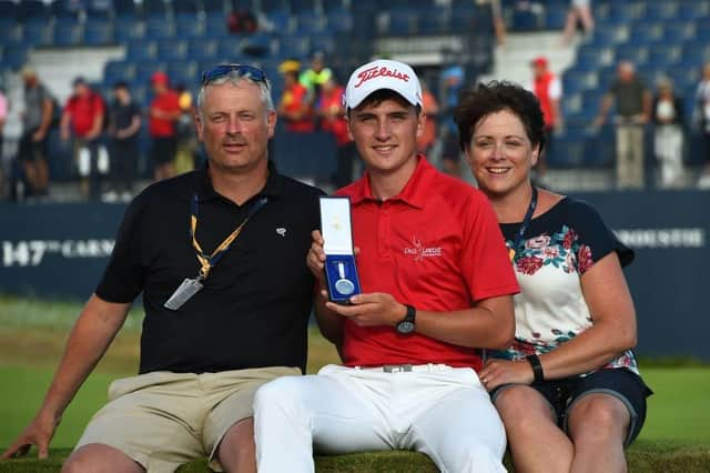 Sam Locke, flanked by his parents, shows off the Silver Medal after finishing as leading amateur in 2018 Open at Carnoustie. Picture: Andy Buchanan/AFP via Getty Images.