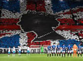 Rangers and Napoli players observe a minute's silence to mark the death of Queen Elizabeth II ahead of the Champions League match at Ibrox. (Photo by ANDY BUCHANAN/AFP via Getty Images)