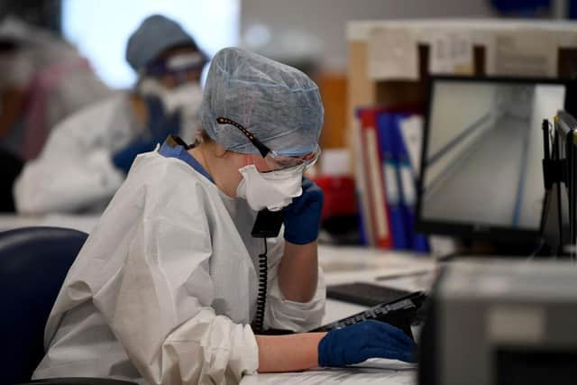 A member of staff at University Hospital Monklands makes a telephone call on the ICU ward on February 5, 2021 in Airdrie, Scotland. Photo by Jeff J Mitchell/Getty Images