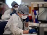 A member of staff at University Hospital Monklands makes a telephone call on the ICU ward on February 5, 2021 in Airdrie, Scotland. Photo by Jeff J Mitchell/Getty Images
