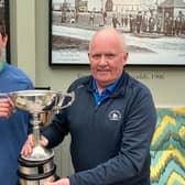 Kilspinde trainee professional Rob Paterson, left, is presented with The UniRoyal Trophy by Edinburgh & East of Scotland Alliance secretary Alan Greenshields after his win at Gullane. Picture: East Alliance