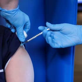 A member of staff receives the Pfizer/BioNTech COVID-19 vaccine at the Abercorn House Care Home in Hamilton.